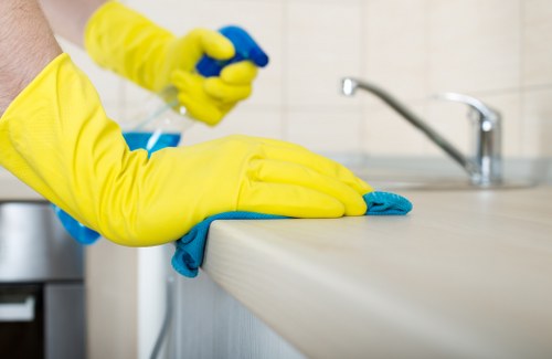 Technician cleaning a mattress in a North London flat